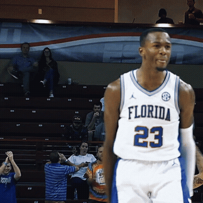 a florida basketball player wearing number 23 stands on the court