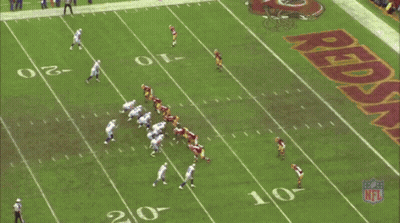 A Football Field With A Large Redskins Logo On It GIF