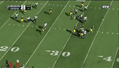 A Football Game Between Michigan And Washington Is Being Played GIF