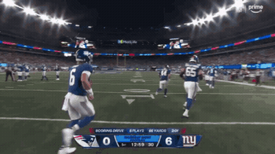 A Football Game Between The Patriots And New York Giants GIF