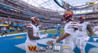 A Football Game Between The Washington Redskins And The La Chargers GIF