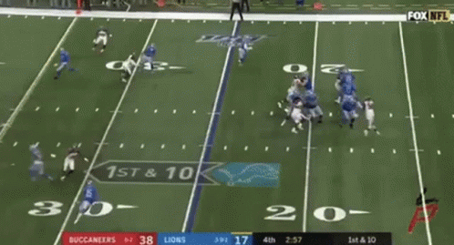 A Football Game Is Being Played Between The Buccaneers And The Lions . GIF