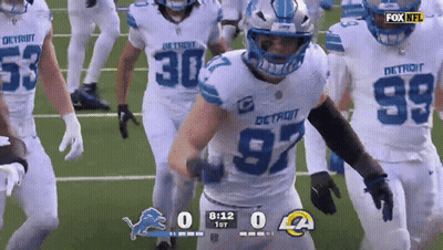 A Football Game Is Being Played Between The Detroit Lions And Los Angeles Rams GIF
