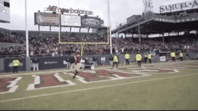 A Football Game Is Being Played In A Stadium Sponsored By Samuel Adams GIF