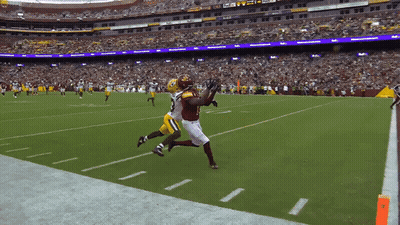 A Football Game Is Being Played In A Stadium With A Fedex Sign In The Background GIF