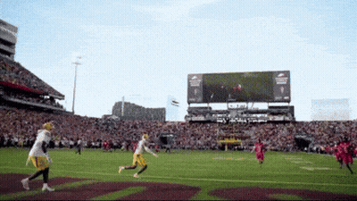 A Football Game Is Being Played In A Stadium With A Scoreboard That Says Ram GIF