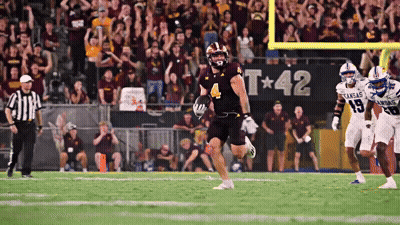 A Football Game Is Being Played In Front Of A Banner That Says Kansas GIF