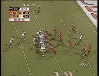 A Football Game Is Being Played In Front Of A Crowd GIF