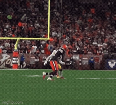 A Football Game Is Being Played In Front Of A Large Crowd GIF