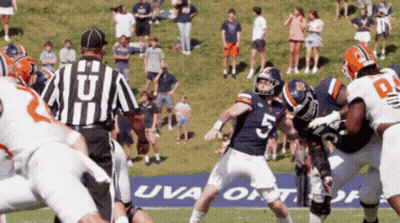 A Football Game Is Being Played In Front Of A Uva Banner GIF