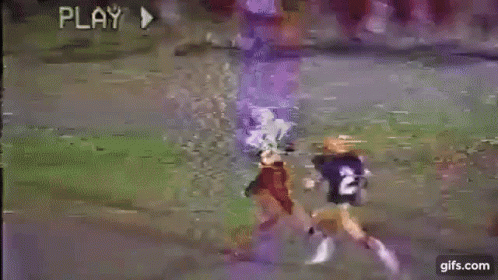 A Football Game Is Being Played On A Field . GIF