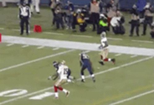 A Football Game Is Being Played On A Field With A Blurred Background . GIF