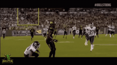 A Football Game Is Being Played On A Field With A Bullpen Logo In The Background . GIF
