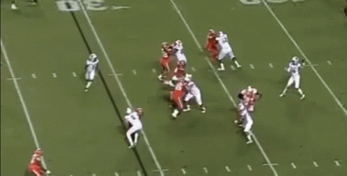 A Football Game Is Being Played On A Field With Players Wearing Red And White Uniforms . GIF