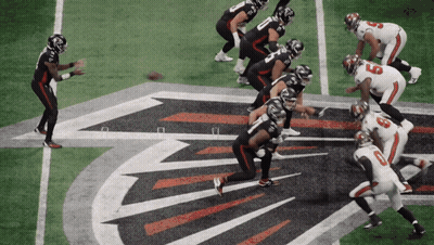 A Football Game Is Being Played On A Field With The Falcons Logo In The Background GIF