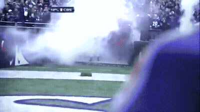 A Football Game Is Being Played On Cbs And Smoke Is Coming Out Of The Stands GIF