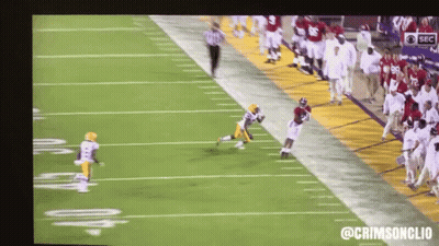 A Football Game Is Being Shown On A Large Screen With The Hashtag @Crimsonclio GIF