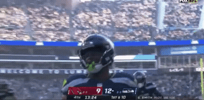 A Football Player Celebrates A Touchdown During A Game GIF