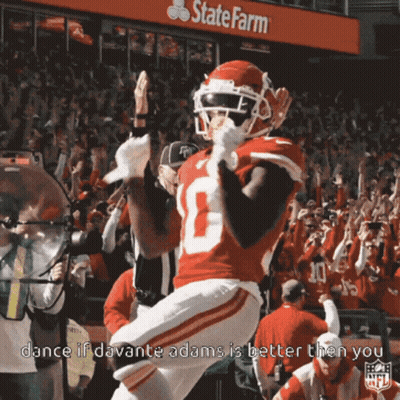 A Football Player Celebrates In Front Of A State Farm Banner GIF