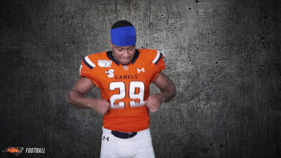 A Football Player For The Camels Is Adjusting His Jersey GIF