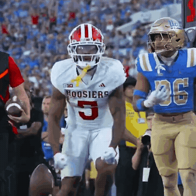 A Football Player For The Hoosier 'S Is Running With The Ball GIF