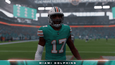 A Football Player For The Miami Dolphins Stands On A Field GIF