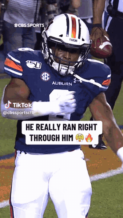 A Football Player From The Auburn Tigers Is Holding A Football GIF