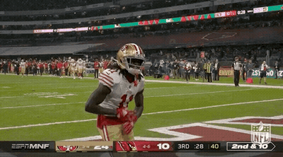 A Football Player In A 49Ers Uniform Stands On A Field GIF