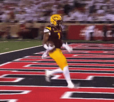 A Football Player In A Black And Yellow Uniform Is Running On The Field GIF