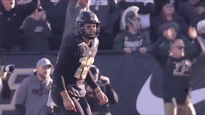 A Football Player In A Black Uniform With The Number 22 On It GIF
