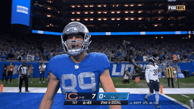 A Football Player In A Blue Jersey With The Number 89 On It GIF