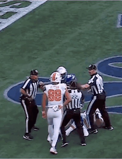 A Football Player In A Blue Uniform With The Number 99 On It GIF