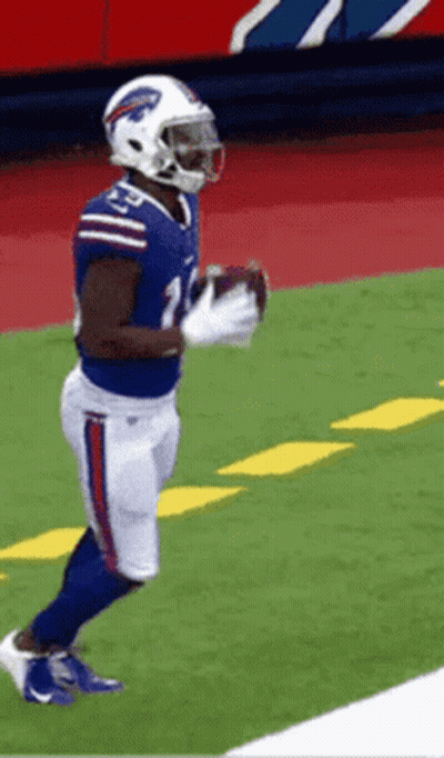 A Football Player In A Buffalo Bills Uniform Is Holding A Football GIF