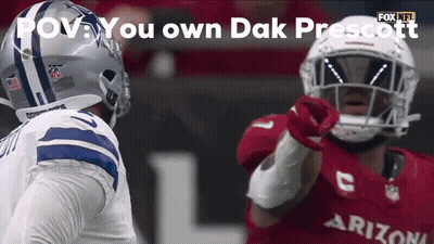A Football Player In A Cowboys Uniform Is Pointing At Another Player In A Cardinals Uniform GIF
