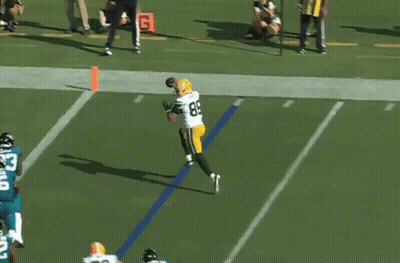 A Football Player In A Green Bay Packers Uniform Catches A Ball GIF