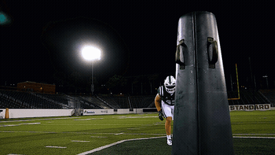 A Football Player In A Green Uniform With The Number 44 On It GIF