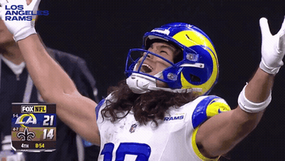 A Football Player In A Los Angeles Rams Uniform Is Celebrating With His Arms In The Air GIF