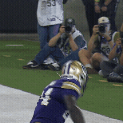 A Football Player In A Purple Jersey With The Number 53 On The Back GIF