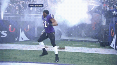 A Football Player In A Purple Uniform With The Number 12 On It GIF