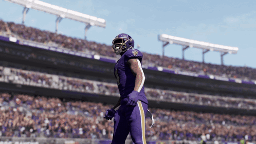 A Football Player In A Purple Uniform With The Number 18 On His Helmet GIF