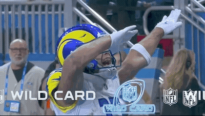 A Football Player In A Rams Helmet Is Celebrating A Touchdown During A Game . GIF