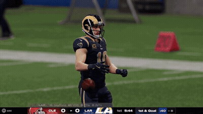 A Football Player In A Rams Uniform Stands On The Field GIF