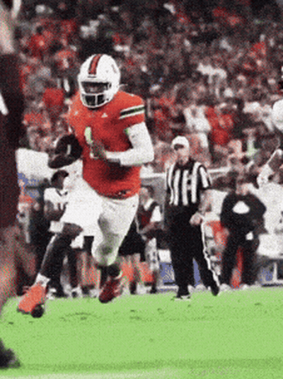 A Football Player In A Red Jersey With The Number 1 On It Is Running With The Ball GIF