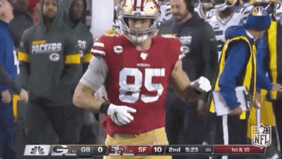 A Football Player In A Red Jersey With The Number 85 On It Is Standing On The Field . GIF