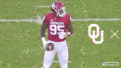 A Football Player In A Red Uniform With The Number 35 On It GIF