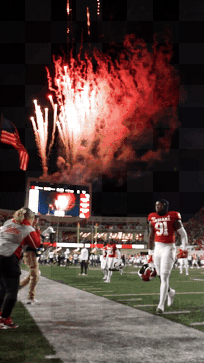 A Football Player In A Red Uniform With The Number 91 On It GIF
