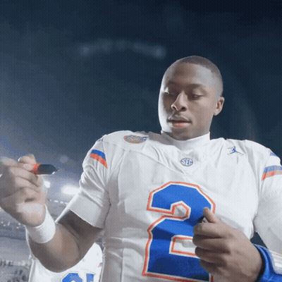 A Football Player In A White Jersey With The Number 2 On It GIF