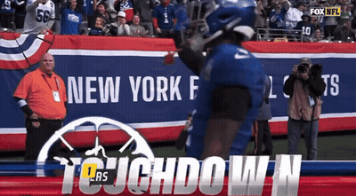 A Football Player In Front Of A Banner That Says Fox Nfl GIF