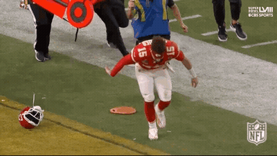 A Football Player Is Being Helped Off The Field By A Nurse . GIF