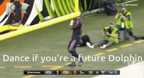 A Football Player Is Dancing On The Field With The Words Dance If You 'Re A Future Dolphin Below Him GIF